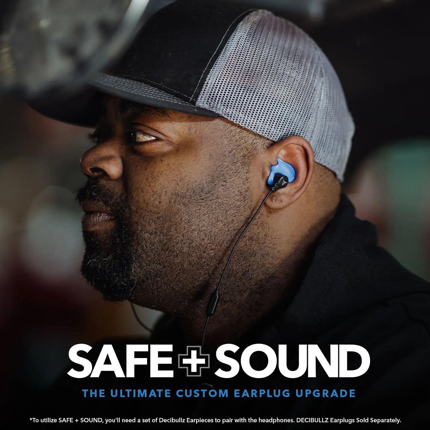 A person wearing a cap and custom earplugs with a wire is looking to the side. The text at the bottom reads, "SAFE + SOUND Wireless Headphone Conversion Kit: The Ultimate Custom Earplug Upgrade" with additional product disclaimer text below. Featuring Noise Suppression Technology, these custom molded headphones offer unbeatable comfort and protection from Decibullz.
