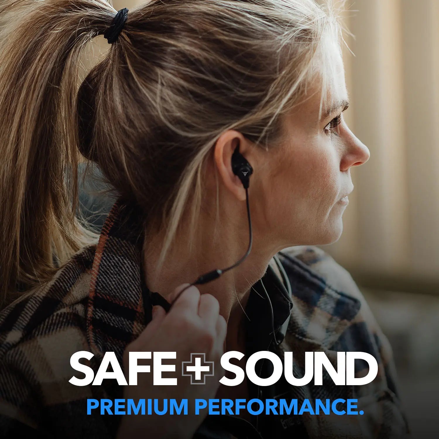 A person with blonde hair is seen from the side wearing Decibullz SAFE + SOUND Custom Molded Bluetooth Wireless Earplug Headphones, featuring Thermofit custom moldable earpieces. They are dressed in a plaid shirt. The words "SAFE + SOUND" and "PREMIUM PERFORMANCE" are displayed at the bottom of the image.